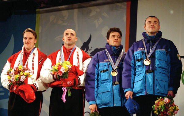 Canada's Pierre Lueders (left) and Dave MacEachern celebrate their gold medal win in the two-man bobsleigh event at the 1998 Nagano Winter Olympics. (CP PHOTO/COA/F. Scott Grant)