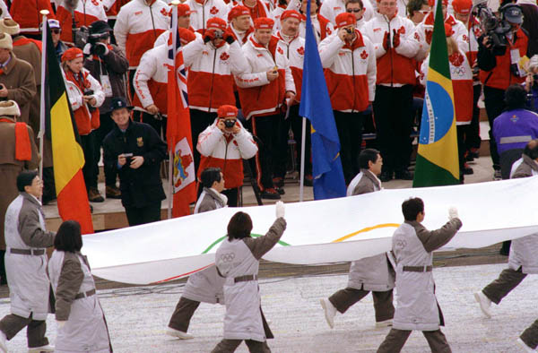Participants carry the Olympic flag during the opening ceremony of the 1998 winter Olympic Games in Nagano. (CP Photo/ COA/F. Scott Grant)