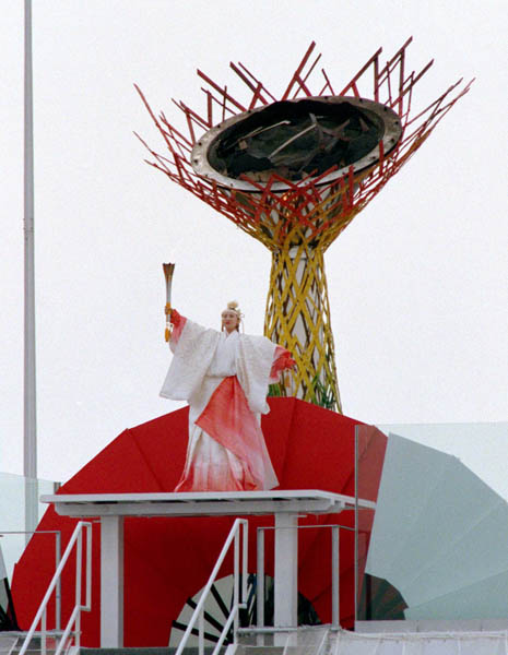 A participant readies to light the Olympic flame during the opening ceremony of the 1998 Winter Olympic Games in Nagano. (CP Photo/ COA/F. Scott Grant)