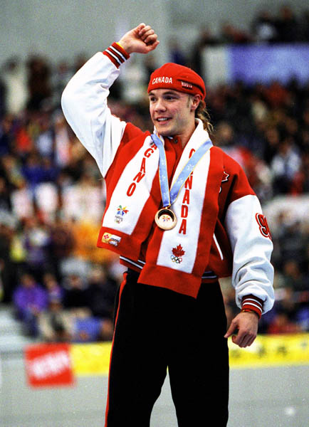 Canada's Kevin Overland celebrates after winning a bronze medal in the long track speed skating event at the 1998 Nagano Winter Olympics. (CP PHOTO/COA/Mike Ridewood)