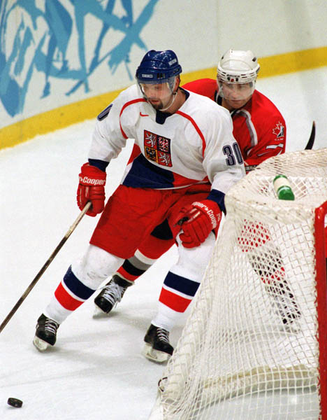 Canada's Ray Bourque (right) competes in hockey action at the 1998 Winter Olympics in Nagano. (CP Photo/COA/ F. Scott Grant )