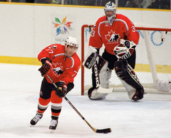 Canada's Ray Bourque (77) and Patrick Roy (goalie) compete in hockey action at the 1998 Winter Olympics in Nagano. (CP Photo/COA/ F. Scott Grant )