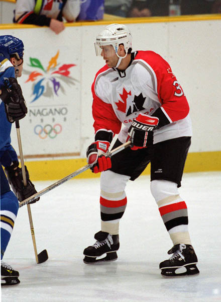 Canada's Eric Desjardins (right) competes in hockey action against Kazakstan at the 1998 Winter Olympics in Nagano. (CP Photo/COA/ F. Scott Grant )