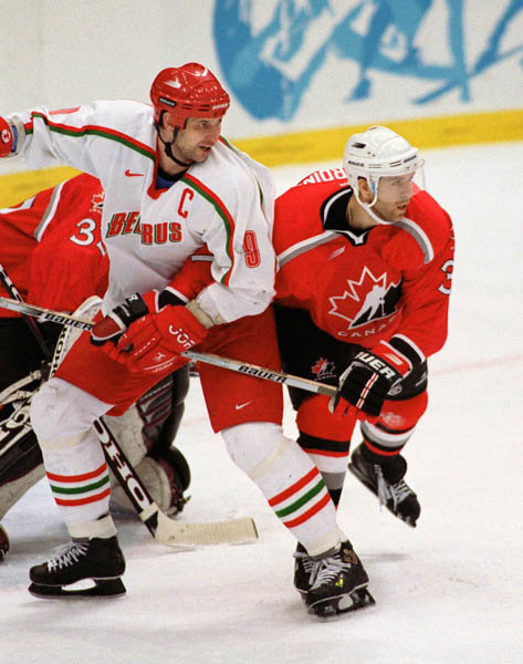 Canada's Eric Desjardins (right) competes in hockey action against Belarus at the 1998 Winter Olympics in Nagano. (CP Photo/COA/ F. Scott Grant )