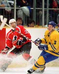 Canada's Eric Desjardins (37) and Theoren Fleury (74) compete in hockey action against the Czech Republic at the 1998 Winter Olympics in Nagano. (CP Photo/COA/ F. Scott Grant )