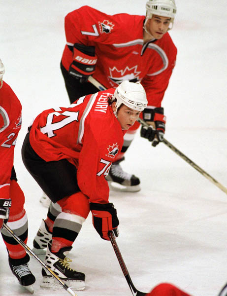 Canada's Theoren Fleury (74) and Rob Zamuner (7) compete in hockey action at the 1998 Winter Olympics in Nagano. (CP Photo/COA/ F. Scott Grant )