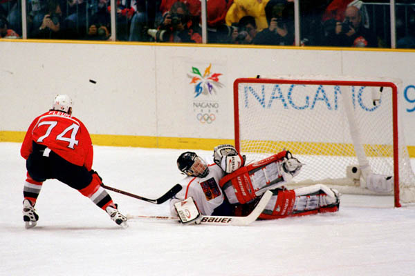 Canada's Theoren Fleury's (left) shot is deflected by the Czech Republic goalie during hockey action at the 1998 Winter Olympics in Nagano. (CP Photo/COA/ F. Scott Grant )