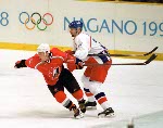 Theoren Fleury (74) tries to score on USA goalie Mike Richter during hockey action Sunday Feb. 24, 2002 at the 2002 Olympic Winter Games in Salt Lake City. Team Canada won 5-2 over Team USA for the gold. (CP Photo/COA/Andre Forget).
