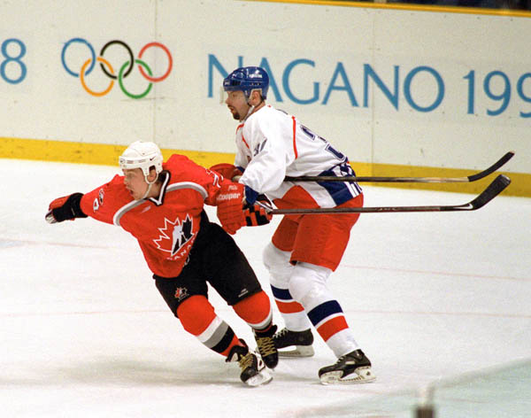 Canada's Theoren Fleury (left) competes in hockey action against the Czech Republic at the 1998 Winter Olympics in Nagano. (CP Photo/COA/ F. Scott Grant )