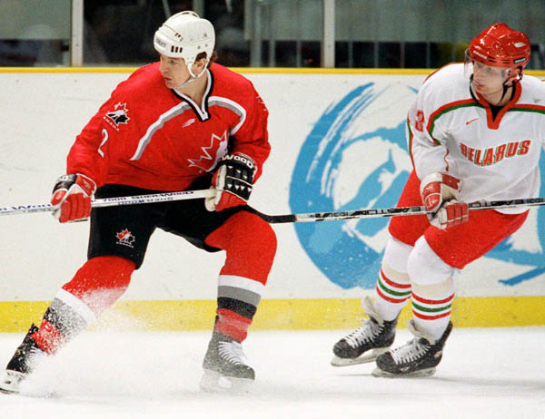 Canada's Allan MacInnis (left) competes in hockey action against Belarus at the 1998 Winter Olympics in Nagano. (CP Photo/COA/ F. Scott Grant )