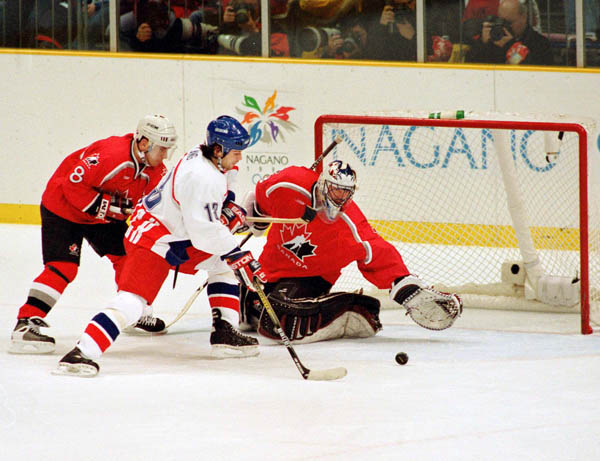 Canada's Eric Lindros (88) and Patrick Roy (goalie) compete in hockey action against the Czech Republic at the 1998 Winter Olympics in Nagano. (CP Photo/COA/ F. Scott Grant )