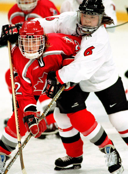 Canada's Hayley Wickenheiser (left) competes in women hockey action against Japan at the 1998 Nagano Winter Olympics. (CP PHOTO/COA/Mike Ridewood)