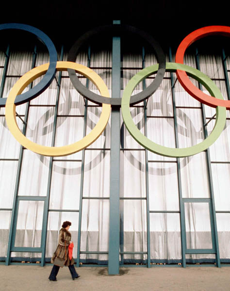 A passer-by walk by the Olympic rings during the opening ceremonies of the 1976 Winter Olympics in Innsbruck. (CP Photo/COA)