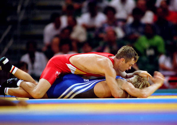 Canada's Marty Caulder (red) competes in the wrestling event at the 1996 Atlanta Olympic Games. (CP Photo/COA/Mike Ridewood)