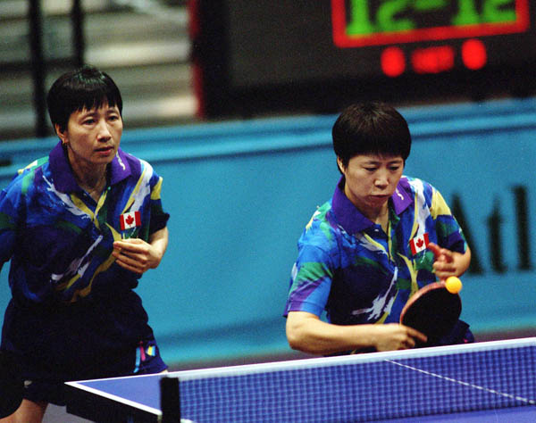 Canada's Barbara Chiu (left) and Lijuan Geng compete in the doubles table tennis event at the 1996 Atlanta Olympic Games. (CP Photo/COA/Scott Grant)