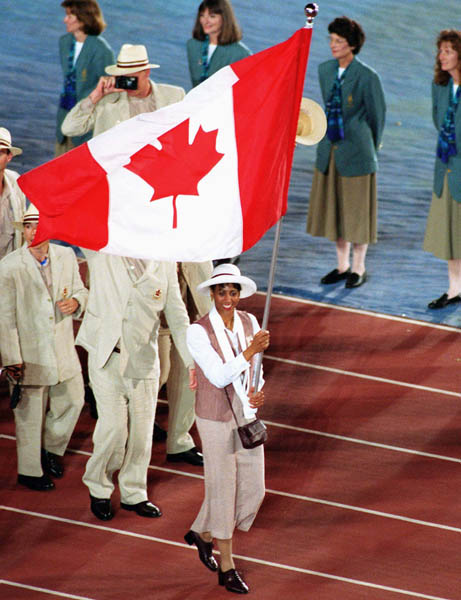 Canada's Charmaine Crooks carries the flag during the opening ceremony at the 1996 Atlanta Summer Olympic Games. (CP PHOTO/COA/F. Scott Grant)