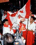 Canada's Jean-Luc Brassard carries the flag as the Canadian team participates in the opening ceremony at the 1998 Nagano Olympic Games. (CP Photo/ COA)