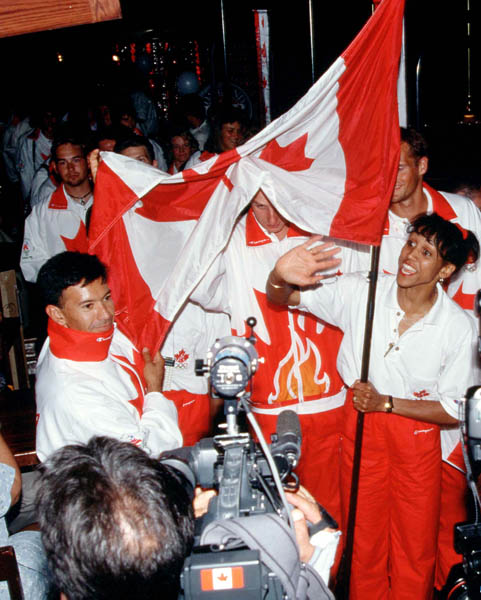 Canada's Charmaine Crooks carries the flag during the team reception at the 1996 Atlanta Summer Olympic Games. (CP Photo/COA/Claus Andersen)