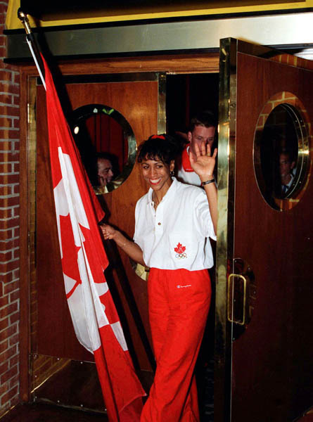 Canada's Charmaine Crooks carries the flag during the team reception at the 1996 Atlanta Summer Olympic Games. (CP Photo/COA/Claus Andersen)