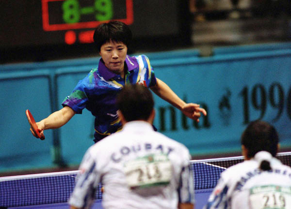 Canada's Lijuan Geng (blue) competes in the doubles table tennis event at the 1996 Atlanta Olympic Games. (CP Photo/COA/Scott Grant)