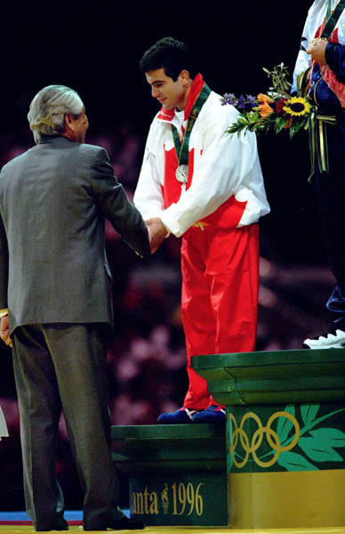 Canada's Guivi Sissaouri celebrates a silver medal he won in the freestyle wrestling event at the 1996 Atlanta Summer Olympic Games. (CP PHOTO/COA/Mike RIdewood)