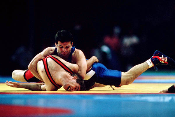 Canada's Guivi Sissaouri (blue) competes in the wrestling event at the 1996 Atlanta Olympic Games. (CP Photo/COA/Mike Ridewood)
