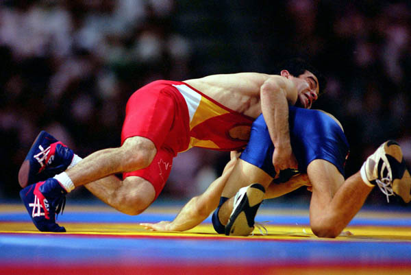 Canada's Guivi Sissaouri (red) competes in the wrestling event at the 1996 Atlanta Olympic Games. (CP Photo/COA/Mike Ridewood)