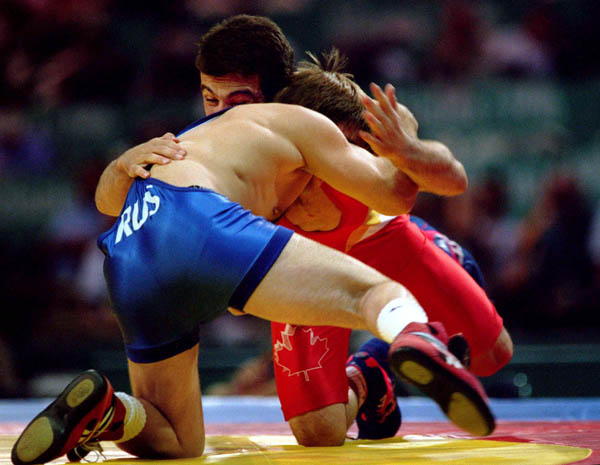 Canada's Guivi Sissaouri (red) competes in the wrestling event at the 1996 Atlanta Olympic Games. (CP Photo/COA/Mike Ridewood)