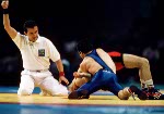 Canada's Greg Woodcroft (blue) competes in the wrestling event at the 1996 Atlanta Olympic Games. (CP Photo/COA/Mike Ridewood)