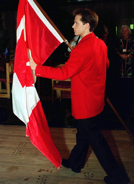 Kurt Browning picks up the flag during his nomination as Canada's flag bearer for the opening ceremonies at the 1994 Winter Olympics in Lillehammer. (CP Photo/COA/F. Scott Grant)