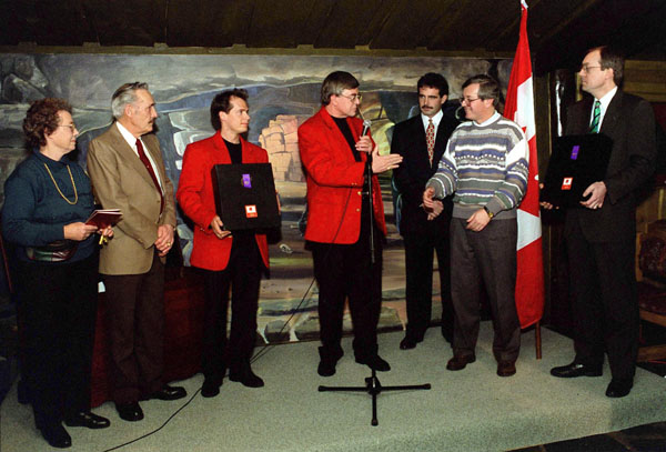 Kurt Browning (third from left) listens to Canadian chef de mission Bill Warren during his nomination as Canada's flag bearer for the opening ceremonies at the 1994 Winter Olympics in Lillehammer. (CP Photo/COA/F. Scott Grant)