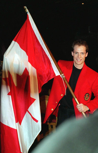 Kurt Browning holds up the Maple Leaf during his nomination as Canada's flag bearer for the opening ceremonies at the 1994 Winter Olympics in Lillehammer. (CP Photo/COA/F. Scott Grant)