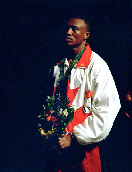 Canada's David Defiagbon celebrates the silver medal he won in the boxing event at the 1996 Atlanta Summer Olympic Games. (CP Photo/COA/Claus Andersen)