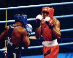 Canada's David Defiagbon (red) competes in the boxing event at the 1996 Atlanta Summer Olympic Games. (CP Photo/COA/Scott Grant)