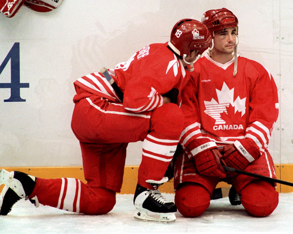 Canada's Todd Warriner (left) and Todd Hlushko participate in hockey action at the 1994 Winter Olympics in Lillehammer. (CP Photo/COA/Claus Andersen)