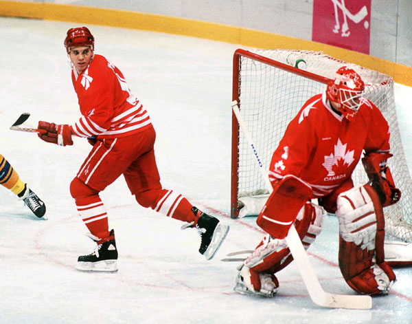 Canada's Greg Johnson and Corey Hirsch (goalie) participate in hockey action at the 1994 Winter Olympics in Lillehammer. (CP Photo/COA/Claus Andersen)