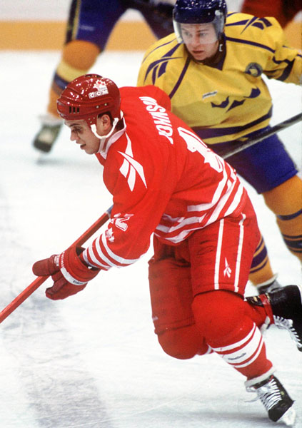 Canada's Greg Johnson (red) participates in hockey action at the 1994 Winter Olympics in Lillehammer. (CP Photo/COA/Claus Andersen)