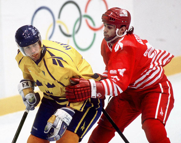 Canada's Mark Astley (right) competes in hockey action against Sweden at the 1994 Winter Olympics in Lillehammer. (CP Photo/COA/Claus Andersen)