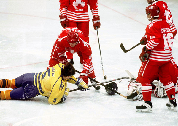 Canada's David Harlock (left) and Wally Schreiber compete in hockey action against Sweden at the 1994 Winter Olympics in Lillehammer. (CP Photo/COA/Claus Andersen)