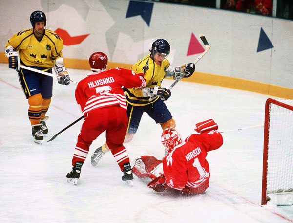 Canada's Todd Hlushko and Corey Hirsch participate in hockey action against Sweden at the 1994 Winter Olympics in Lillehammer. (CP Photo/COA/Claus Andersen)