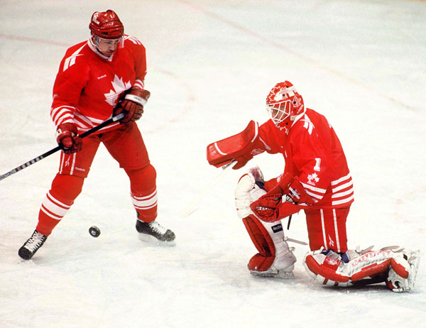 Canada's Derek Mayer (left) and Corey Hirsch compete in hockey action at the 1994 Winter Olympics in Lillehammer. (CP Photo/COA/Claus Andersen)