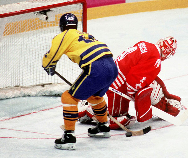 Canada's Corey Hirsch (right) competes in hockey action against Sweden at the 1994 Winter Olympics in Lillehammer. (CP Photo/COA/Claus Andersen)