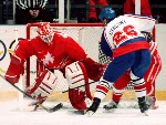 Canada's Corey Hirsch (goalie) and Mark Astley compete in hockey action against Sweden at the 1994 Winter Olympics in Lillehammer. (CP Photo/COA/Claus Andersen)