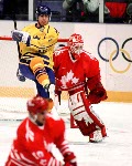 Canada's Corey Hirsch (goalie) and Mark Astley compete in hockey action against Sweden at the 1994 Winter Olympics in Lillehammer. (CP Photo/COA/Claus Andersen)
