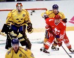 Canada's Todd Hlushko (centre) competes in hockey action at the 1994 Winter Olympics in Lillehammer. (CP Photo/COA/Claus Andersen)
