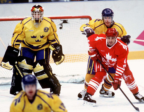 Canada's Todd Hlushko (right) competes in hockey action against Sweden at the 1994 Winter Olympics in Lillehammer. (CP Photo/COA/Claus Andersen)