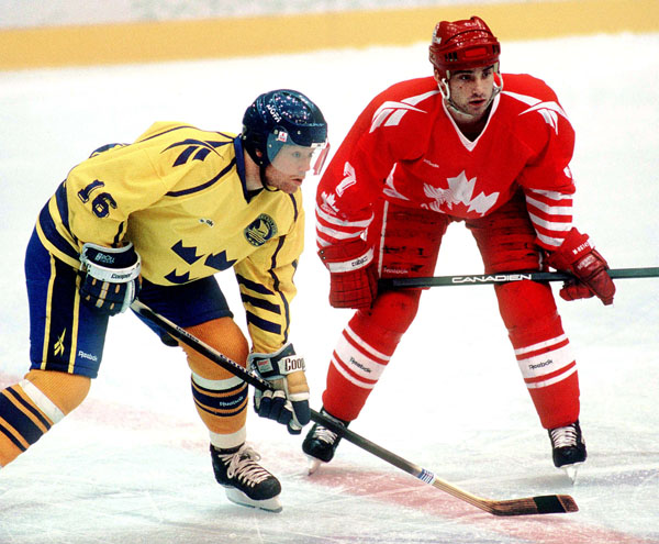 Canada's Todd Hlushko (right) competes in hockey action against Sweden at the 1994 Winter Olympics in Lillehammer. (CP Photo/COA/Claus Andersen)