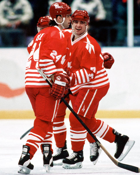 Canada's Todd Hlushko (right) and Mark Astley participate in hockey action at the 1994 Winter Olympics in Lillehammer. (CP Photo/COA/Claus Andersen)