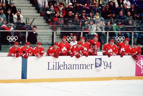 Team Canada and coach Dany Dube watch the action at the 1994 Winter Olympics in Lillehammer. (CP Photo/COA/Claus Andersen)