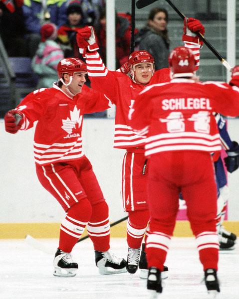 (From left to right) Canada's Chris Kontos, Paul Kariya and Brad Schlegel celebrate during hockey action at the 1994 Winter Olympics in Lillehammer. (CP Photo/COA/Claus Andersen)